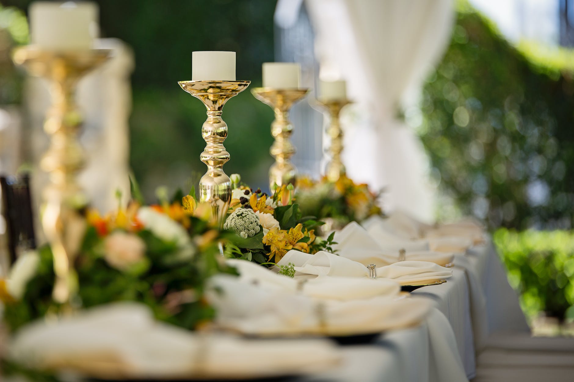 four white tealight candles on brass colored candlesticks