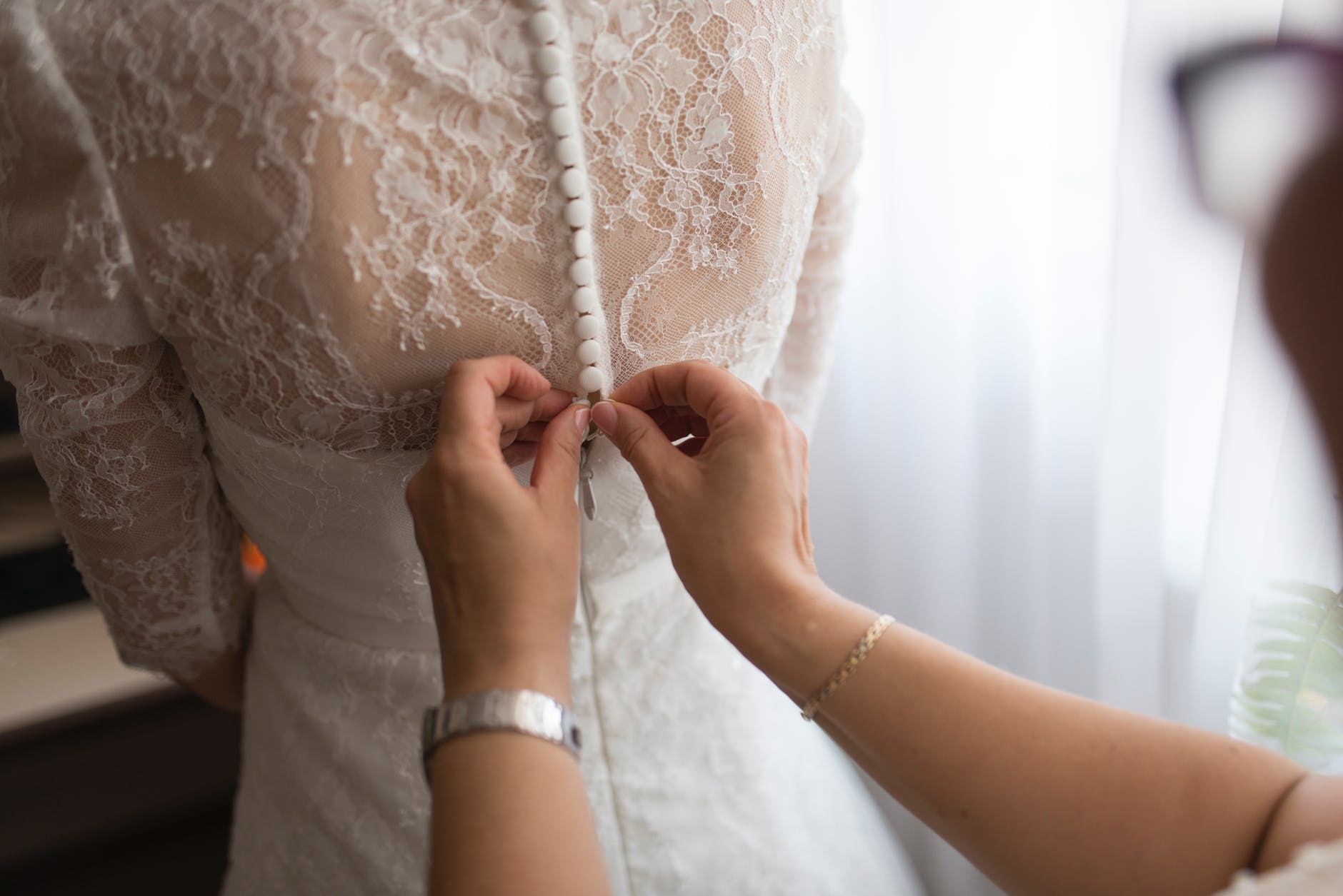 person fixing dress on girl